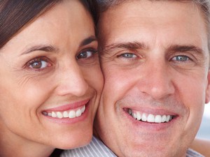 A Couple Smiling After Dental Implants